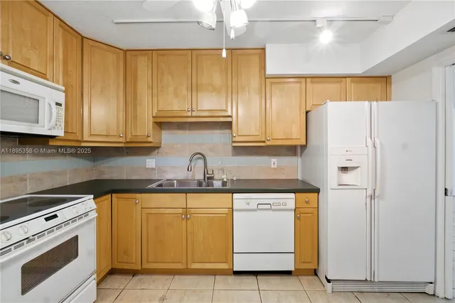 a kitchen with a sink a stove and cabinets