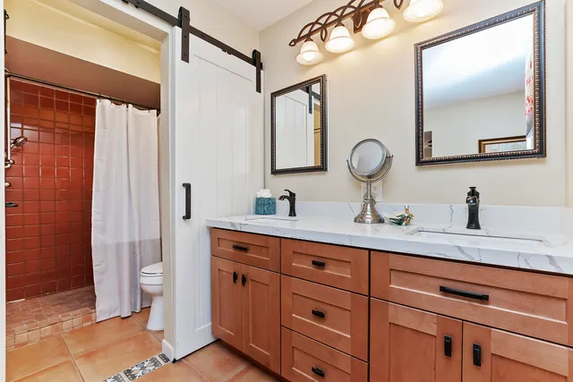 a bathroom with a double vanity sink and a mirror