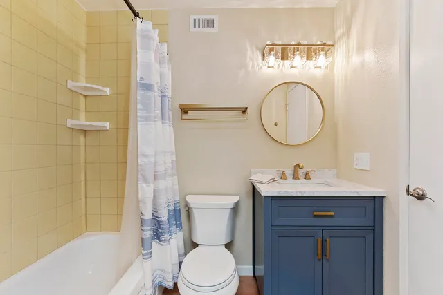 a bathroom with a toilet a sink and bathtub