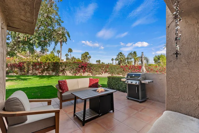 a view of a patio with a yard