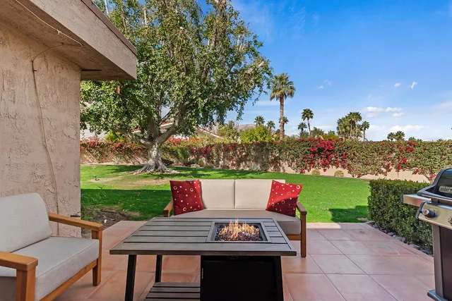 a view of outdoor sitting area with furniture and garden