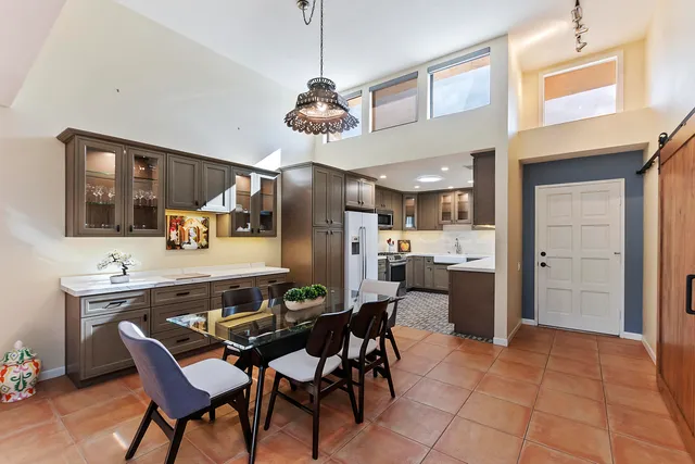 a view of a dining room with furniture and a chandelier