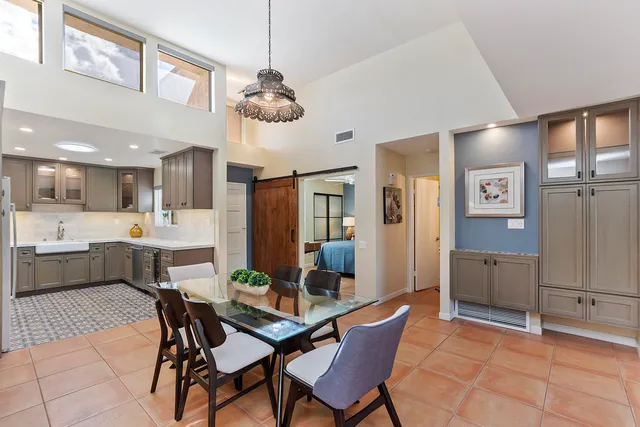 a view of a dining room with furniture and a chandelier