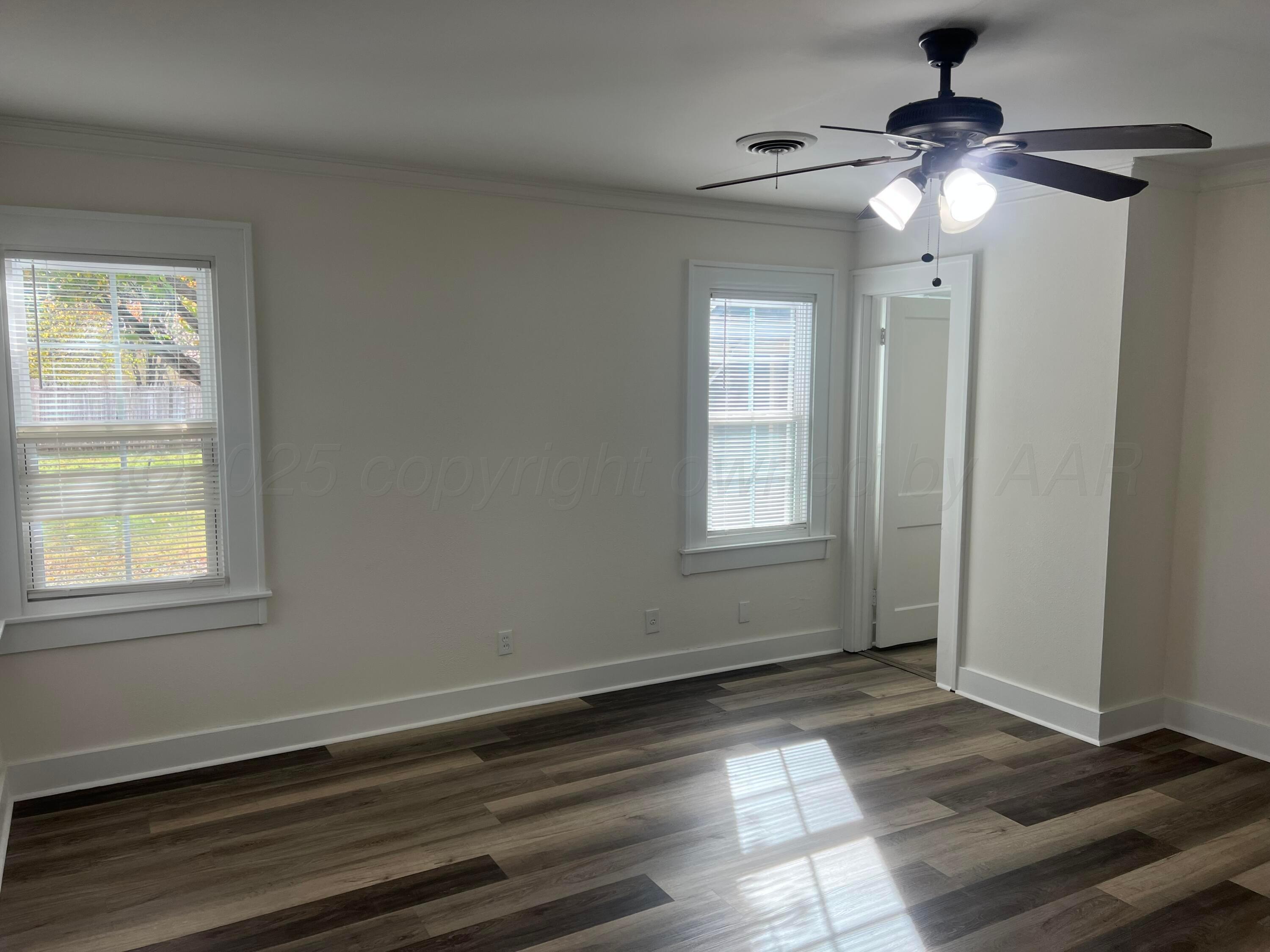 4233 Southwest 13th Avenue Amarillo, TX 79106 - Photo 12 of 55 a view of an empty room with wooden floor and a window