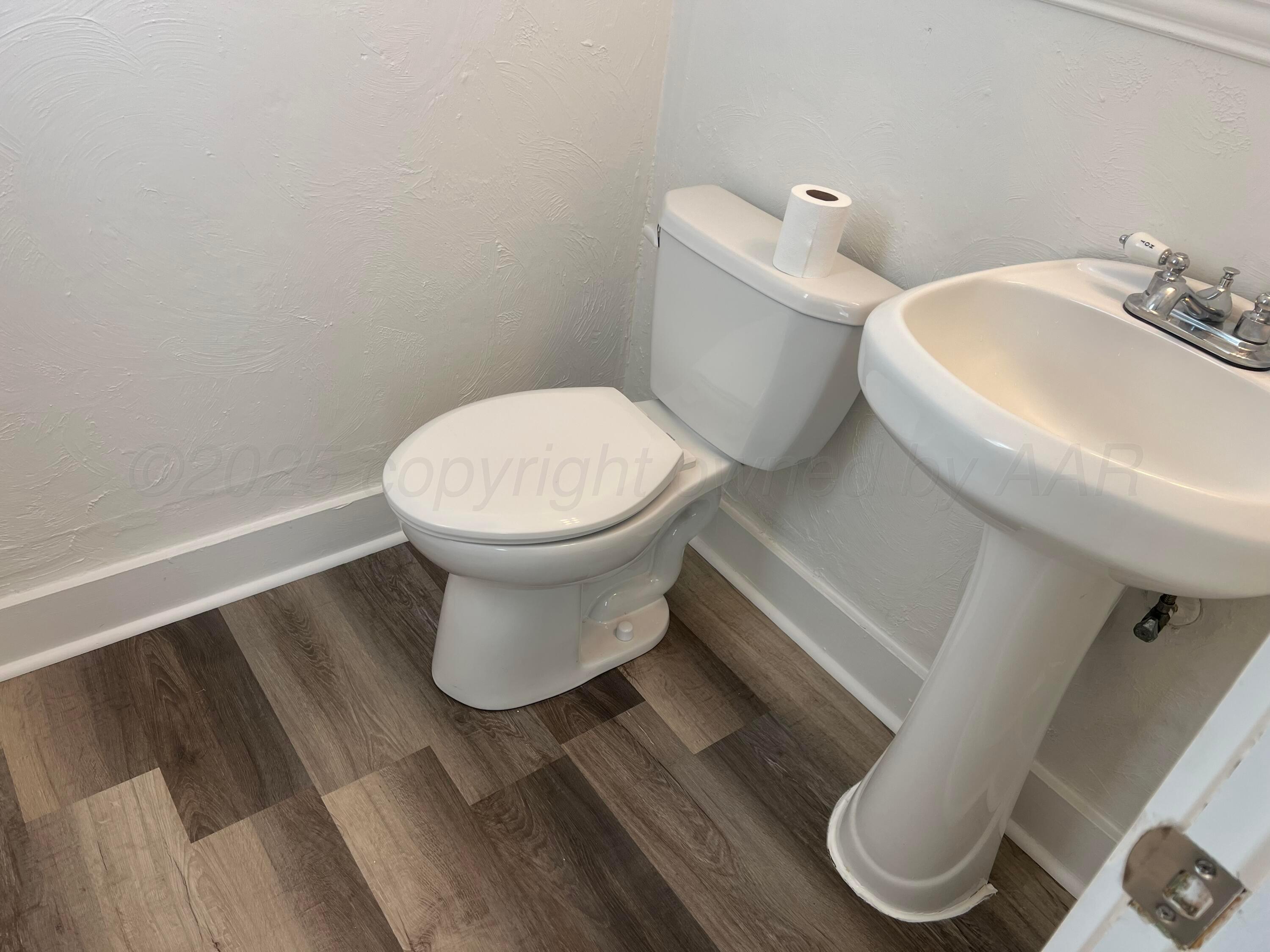 4233 Southwest 13th Avenue Amarillo, TX 79106 - Photo 14 of 55 a white toilet sitting next to a bathroom sink