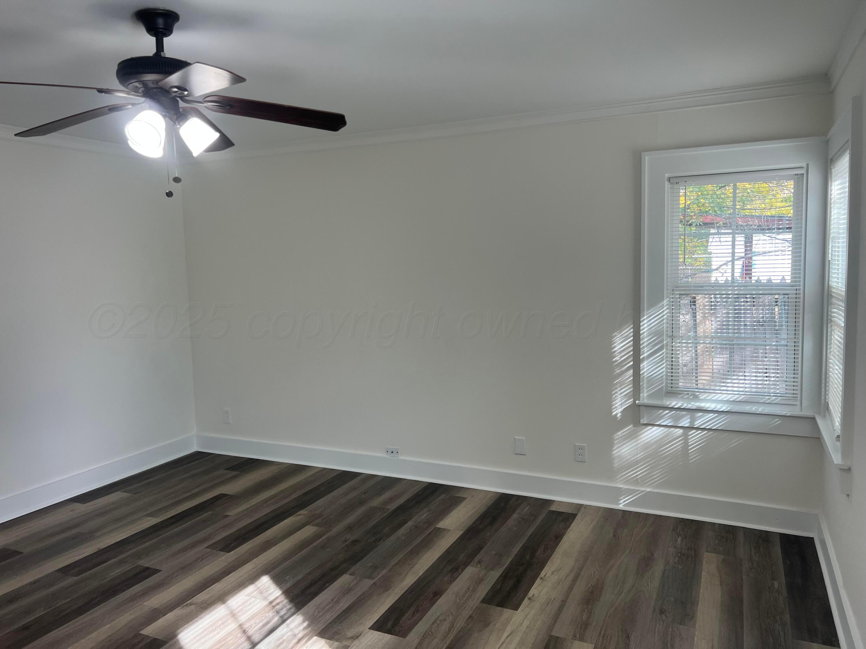 4233 Southwest 13th Avenue Amarillo, TX 79106 - Photo 16 of 55 en empty room with wooden floor fan and window