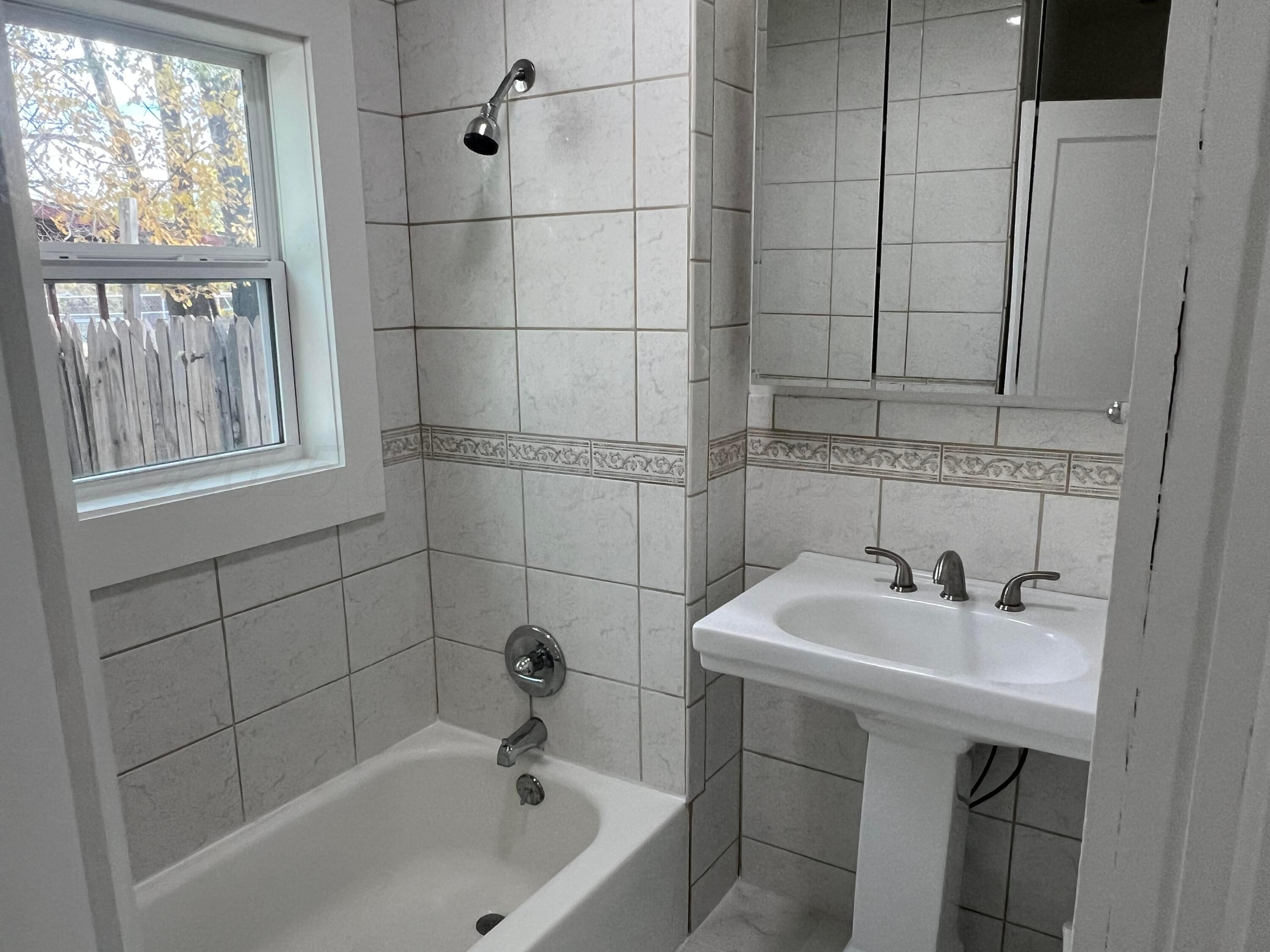 4233 Southwest 13th Avenue Amarillo, TX 79106 - Photo 21 of 55 a bathroom with a sink and a bathtub