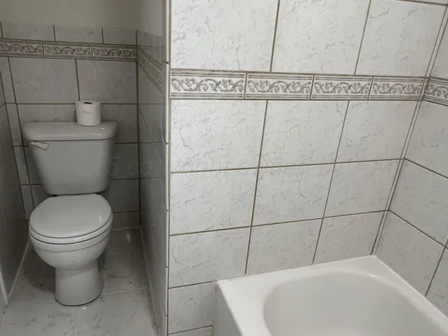 a white toilet sitting next to a bathroom sink