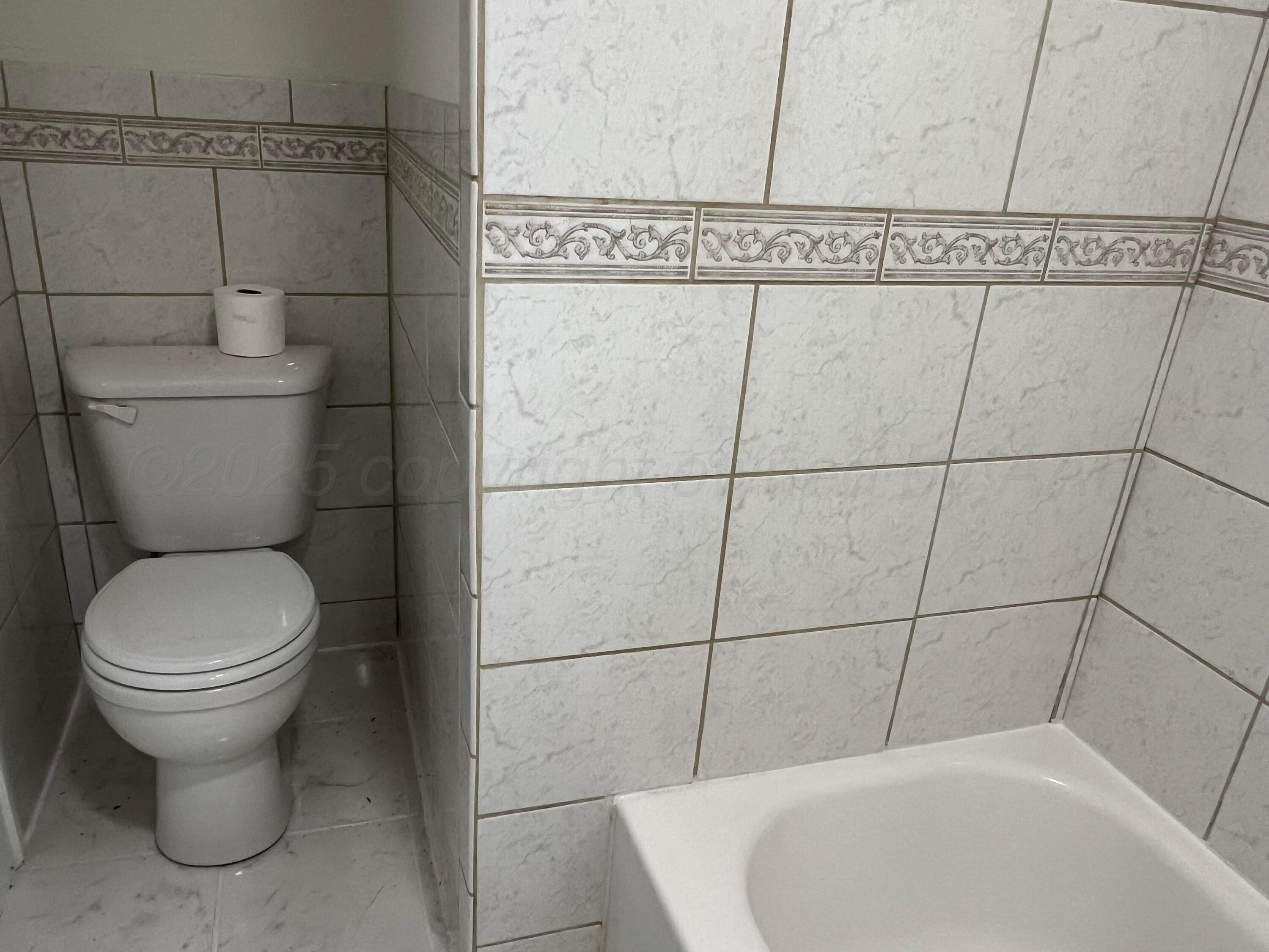 4233 Southwest 13th Avenue Amarillo, TX 79106 - Photo 23 of 55 a white toilet sitting next to a bathroom sink
