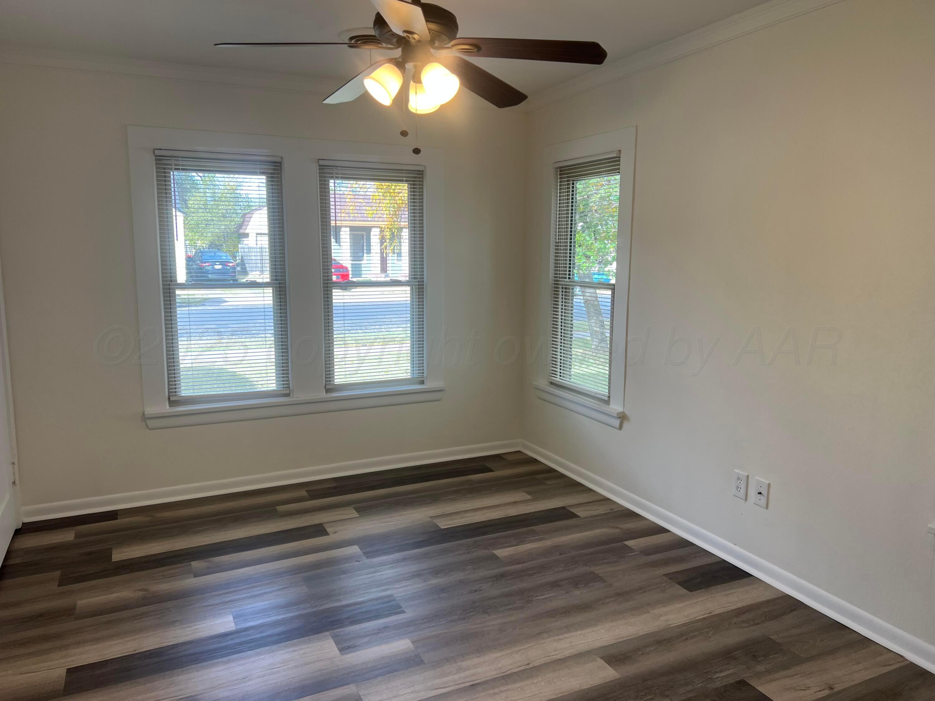 4233 Southwest 13th Avenue Amarillo, TX 79106 - Photo 25 of 55 a view of empty room with wooden floor and fan