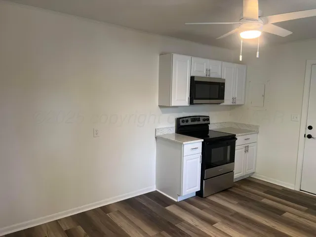 a kitchen with white cabinets