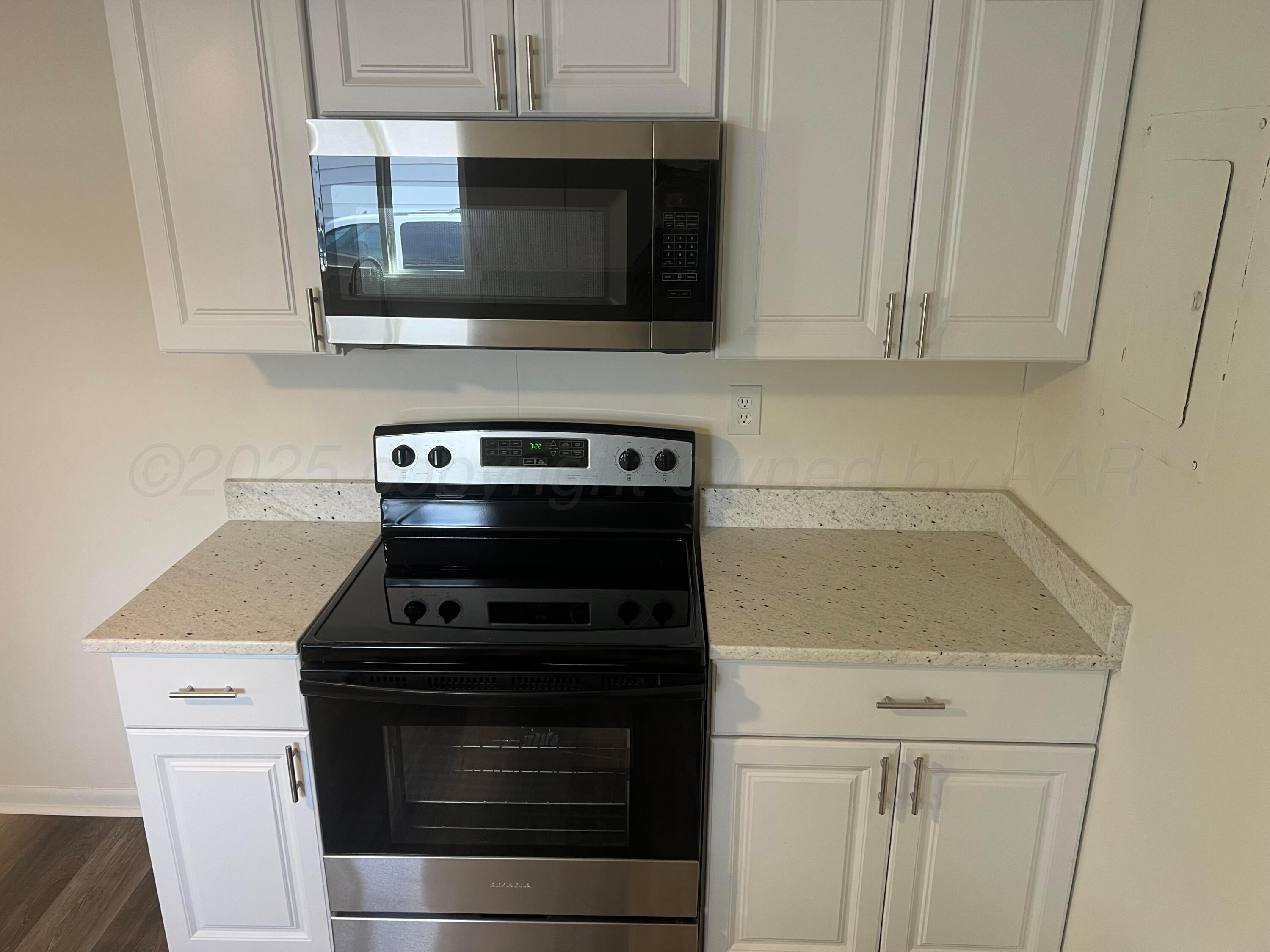 4233 Southwest 13th Avenue Amarillo, TX 79106 - Photo 33 of 55 a kitchen with granite countertop white cabinets stainless steel appliances and a sink