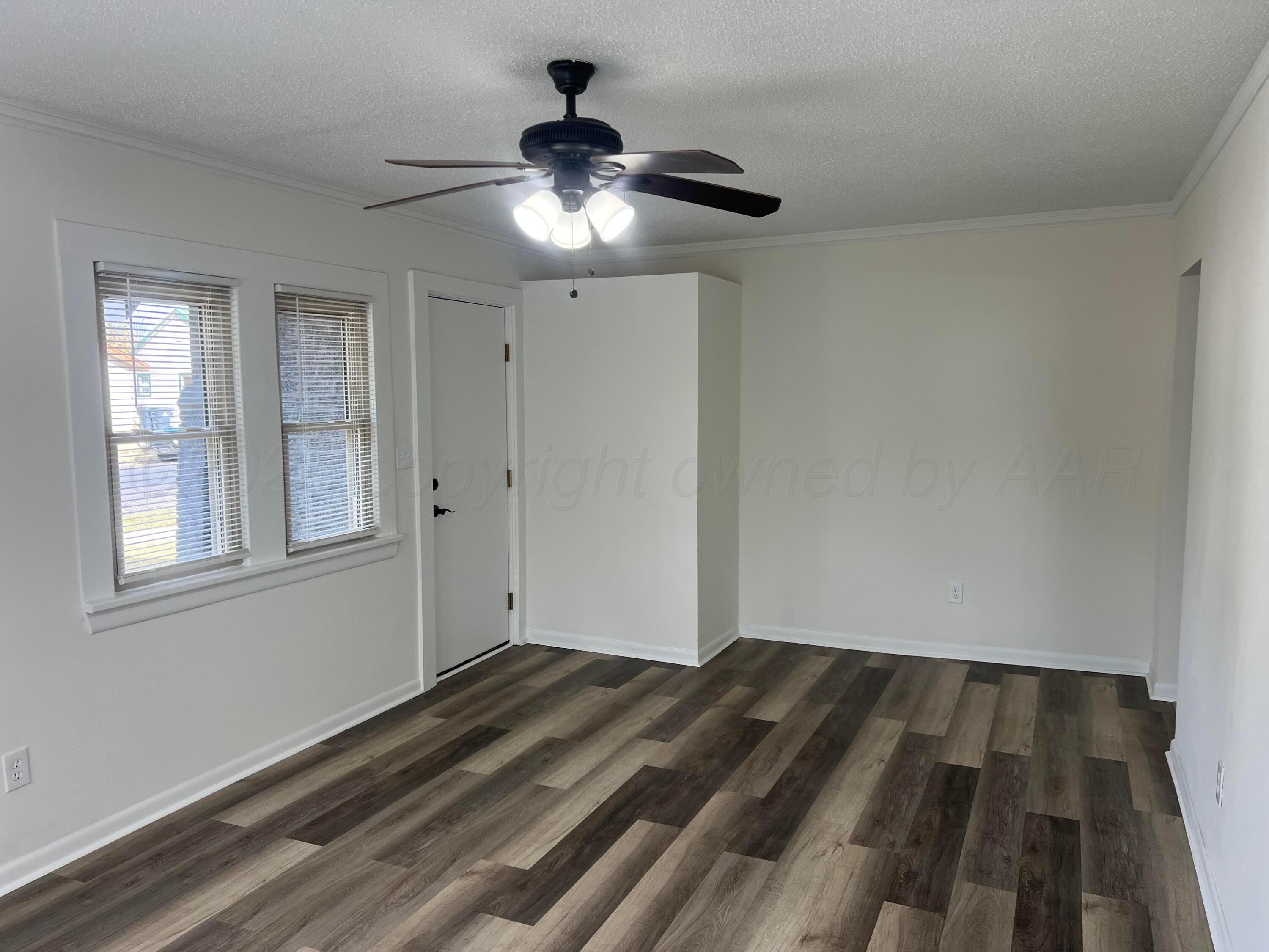 4233 Southwest 13th Avenue Amarillo, TX 79106 - Photo 5 of 55 a view of empty room with wooden floor and fan