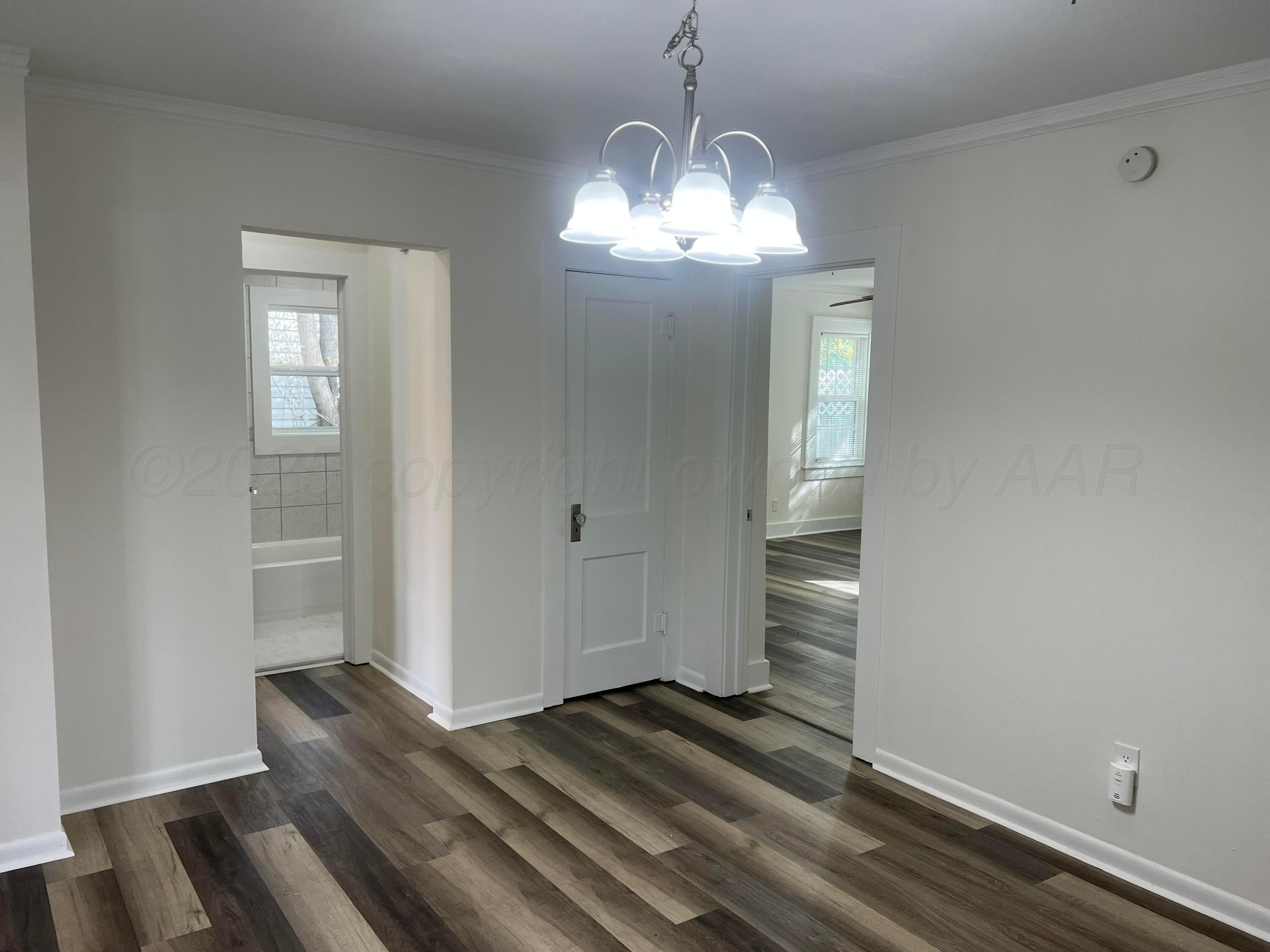 4233 Southwest 13th Avenue Amarillo, TX 79106 - Photo 8 of 55 a view of empty room with wooden floor and fan