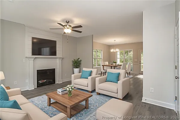 a kitchen with kitchen island a refrigerator a stove a sink and white cabinets with wooden floor