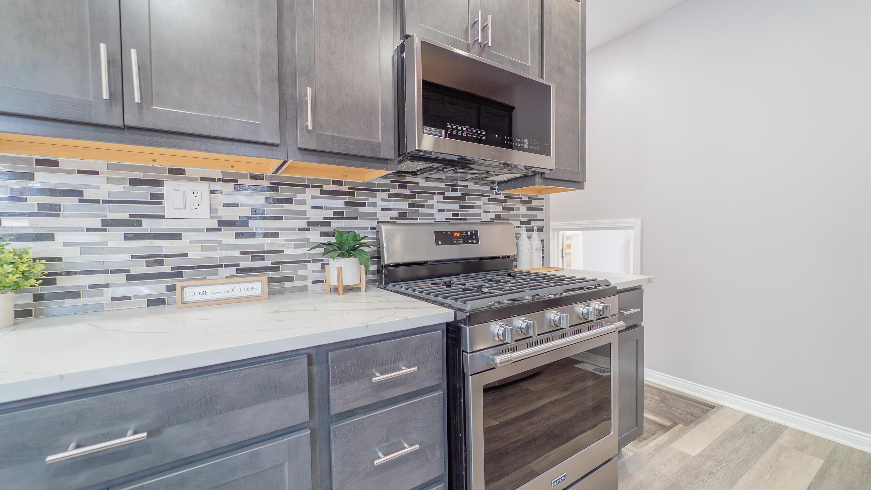 4044 Louisiana Street Gary, IN 46409 - Photo 11 of 31 a kitchen with stainless steel appliances a stove and a microwave