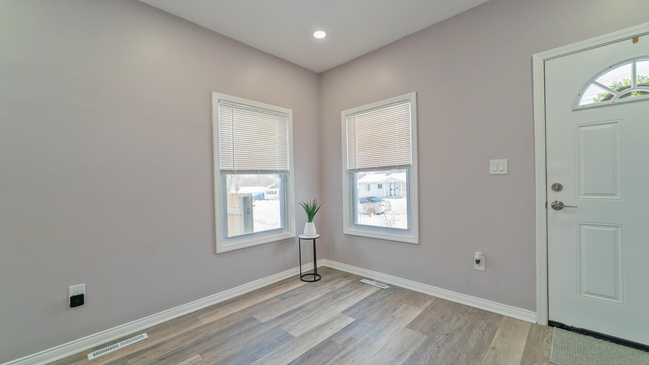 4044 Louisiana Street Gary, IN 46409 - Photo 4 of 31 a view of an empty room with wooden floor and a window