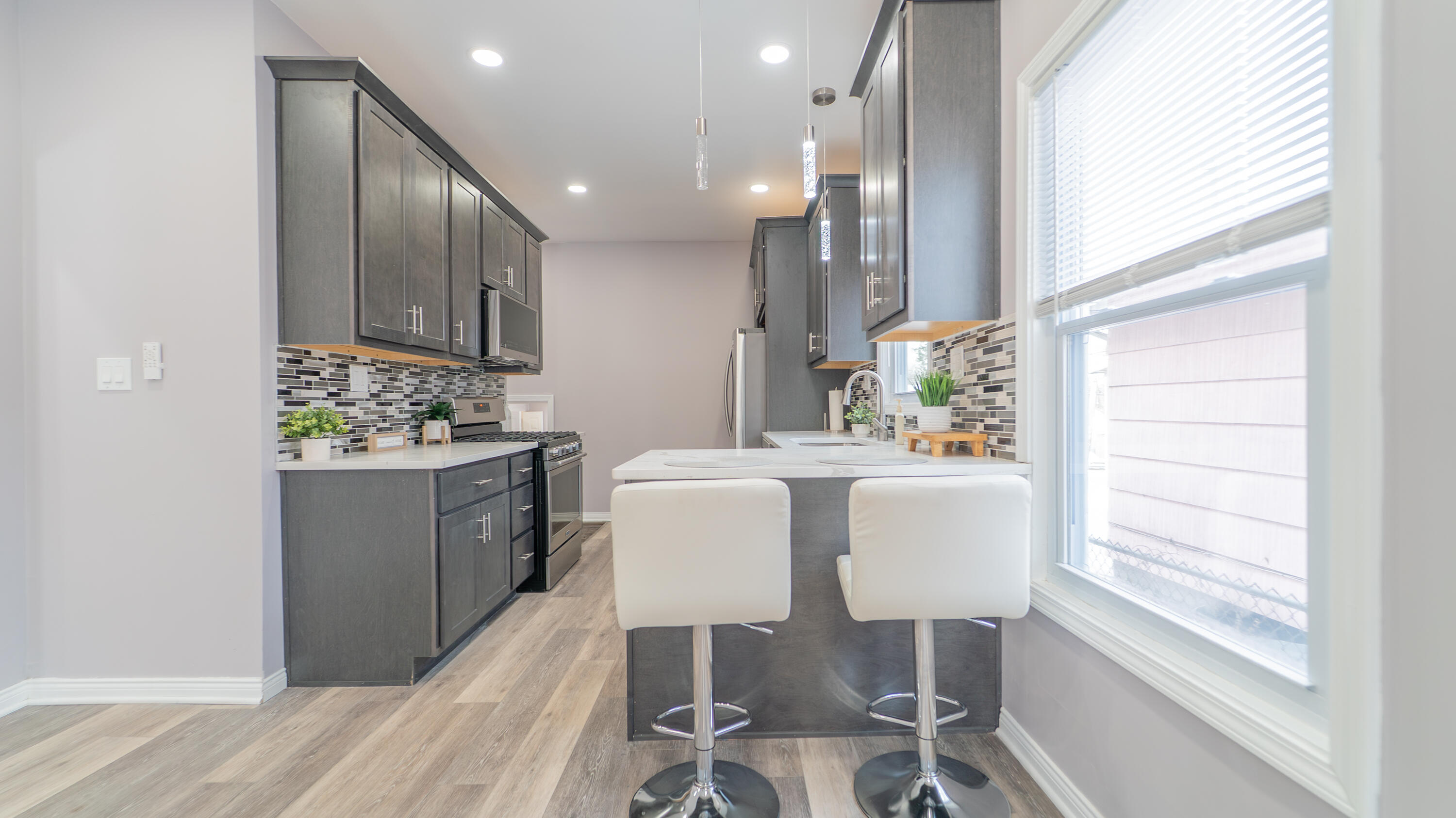 4044 Louisiana Street Gary, IN 46409 - Photo 6 of 31 a dining room with kitchen island furniture a chandelier and kitchen view