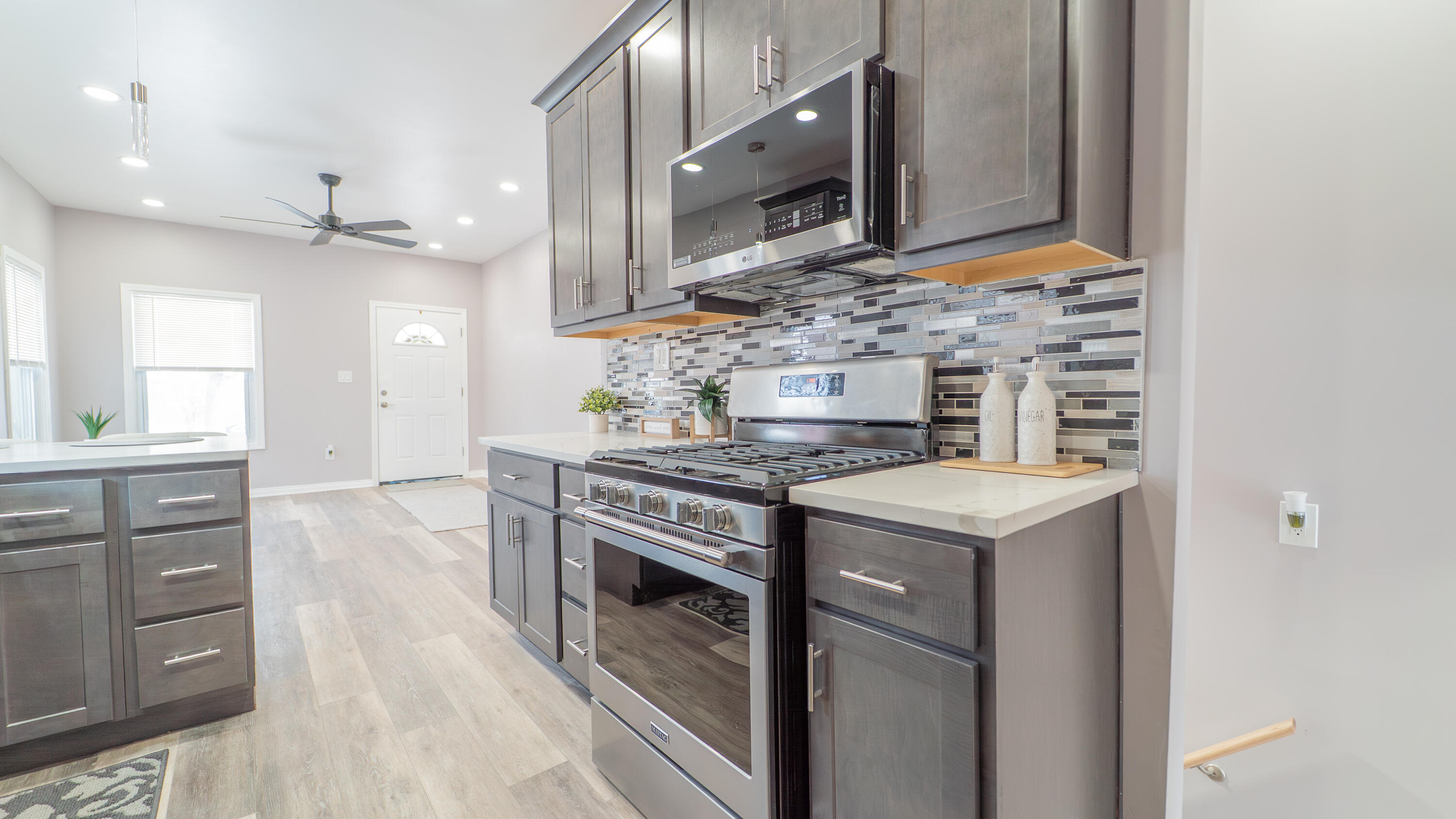 4044 Louisiana Street Gary, IN 46409 - Photo 8 of 31 a kitchen with stainless steel appliances granite countertop a stove and a microwave
