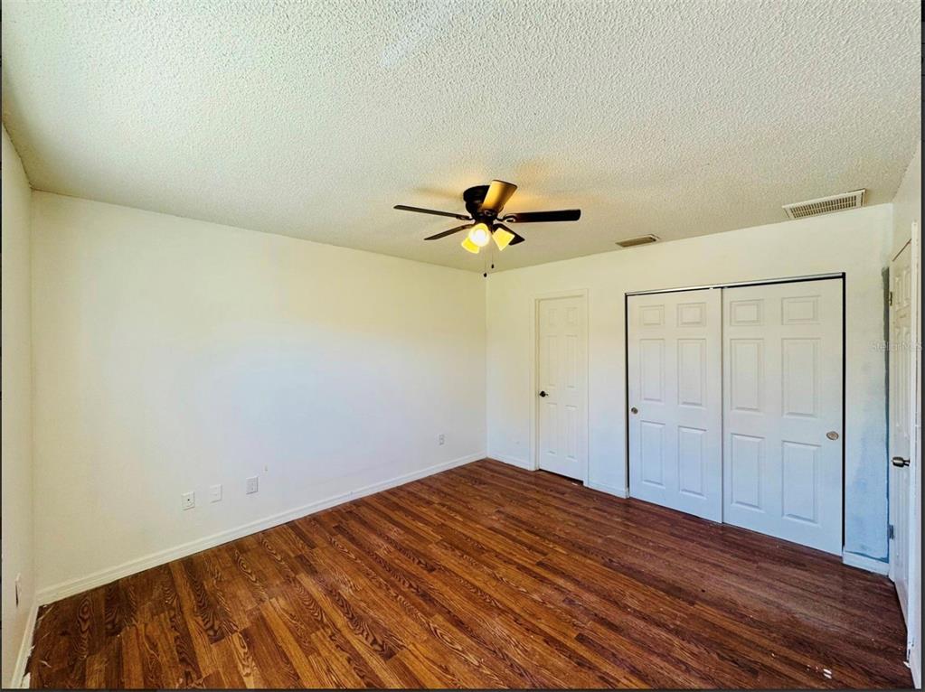 7423 Mohawk Trail Spring Hill, FL 34606 - Photo 12 of 20 a view of empty room with wooden floor