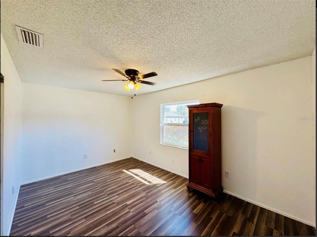 7423 Mohawk Trail Spring Hill, FL 34606 - Photo 14 of 20 a view of empty room with wooden floor