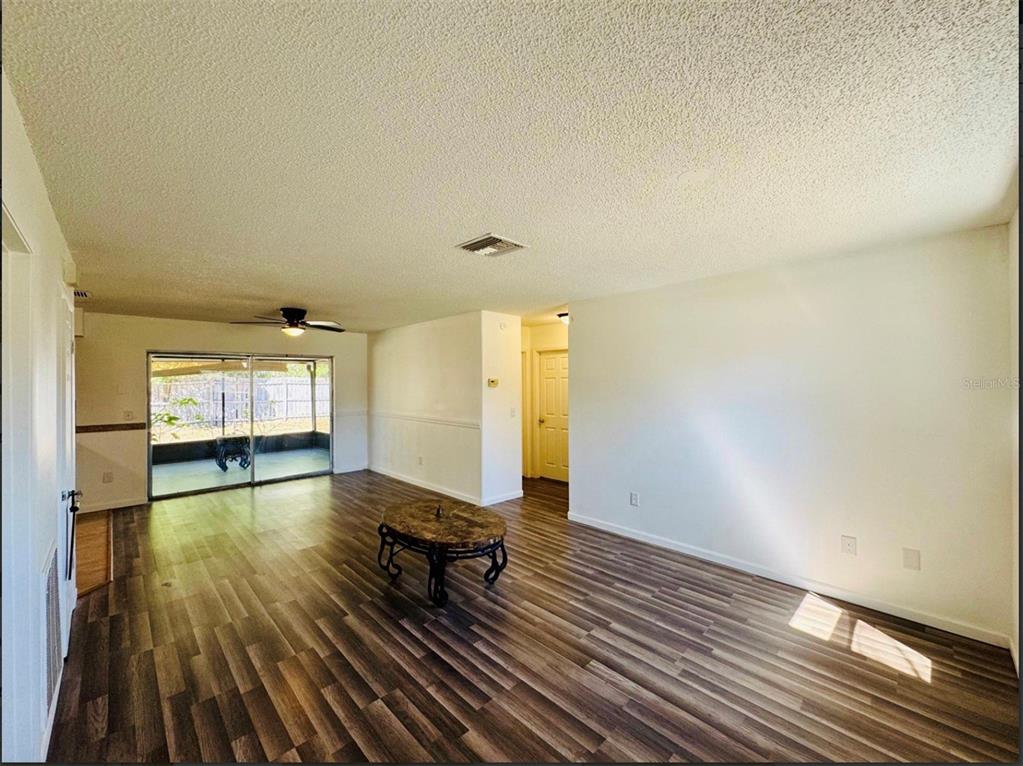 7423 Mohawk Trail Spring Hill, FL 34606 - Photo 18 of 20 a view of empty room with wooden floor and fan