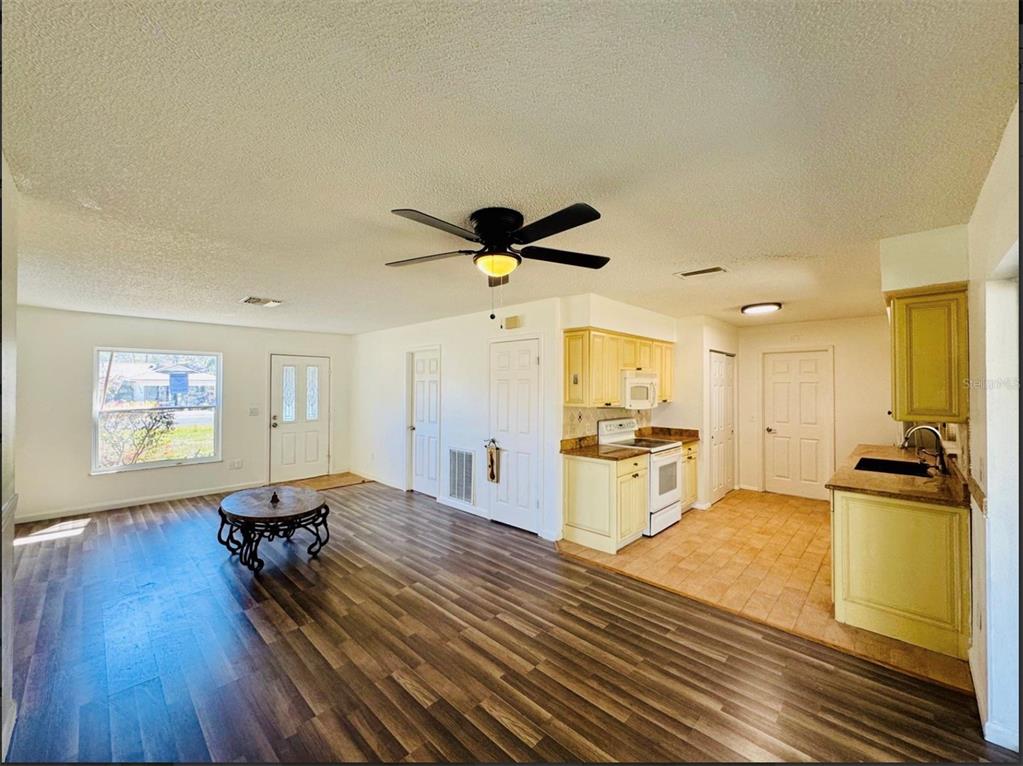 7423 Mohawk Trail Spring Hill, FL 34606 - Photo 20 of 20 a living room with stainless steel appliances kitchen island granite countertop furniture and a kitchen view