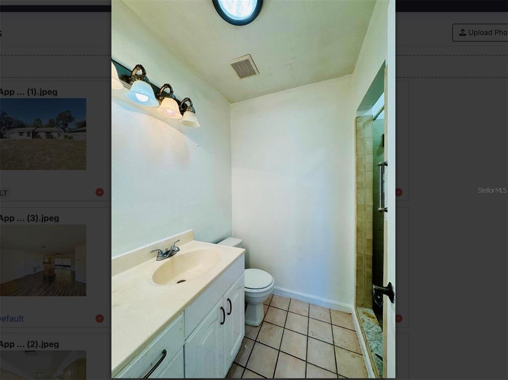 7423 Mohawk Trail Spring Hill, FL 34606 - Photo 7 of 20 a bathroom with a granite countertop sink a toilet and shower