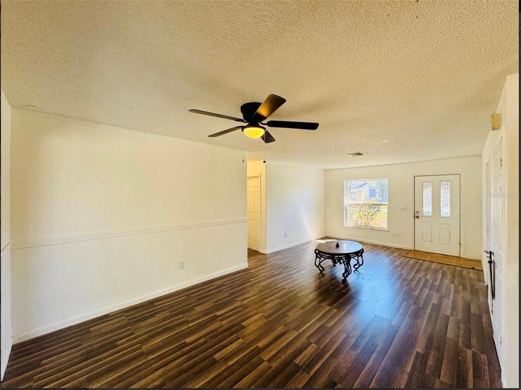 7423 Mohawk Trail Spring Hill, FL 34606 - Photo 10 of 20 a view of workspace with wooden floor and ceiling fan