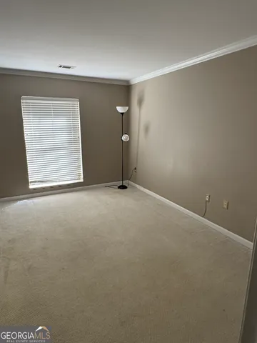 an empty room with windows and closet