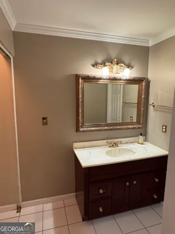 a bathroom with a sink vanity and a mirror
