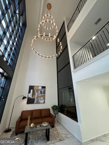 a living room with furniture and a chandelier