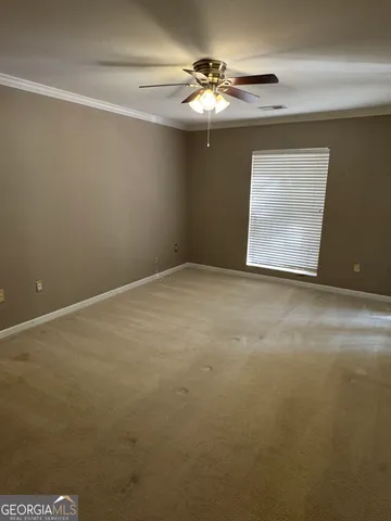 a view of an empty room with windows