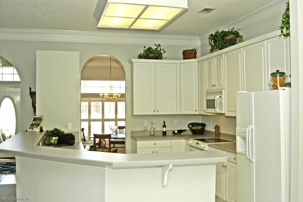 465 Big Tree Road Ponte Vedra, FL 32082 - Photo 7 of 12 a kitchen with a sink a counter appliances and cabinets