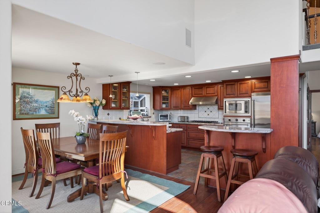 2408 Ocean Drive Oxnard, CA 93035 - Photo 13 of 58 a dining room filled chandelier and wooden floor