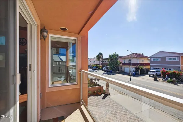 a view of a balcony with couches and wooden floor