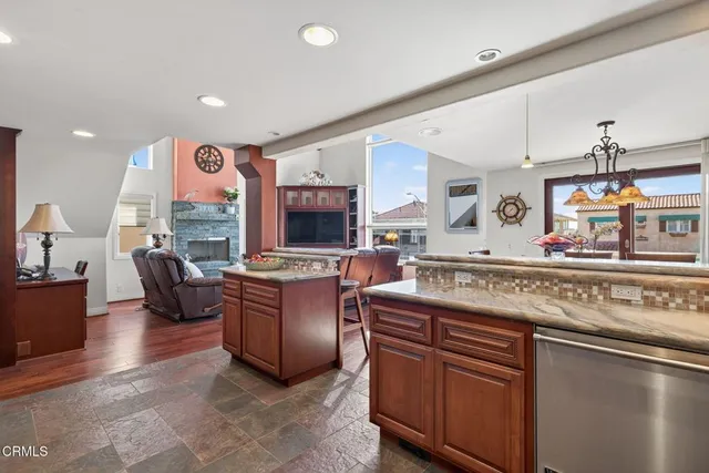 a kitchen with stainless steel appliances granite countertop a sink and cabinets