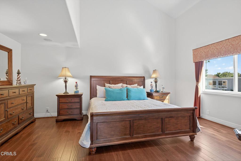 2408 Ocean Drive Oxnard, CA 93035 - Photo 22 of 58 a bedroom with a bed and wooden floor