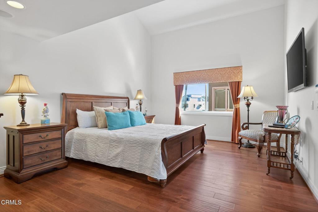 2408 Ocean Drive Oxnard, CA 93035 - Photo 23 of 58 a bedroom with a bed and a flat tv screen on the dresser