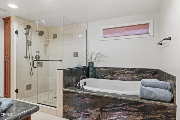 a bathroom with a bathtub and shower