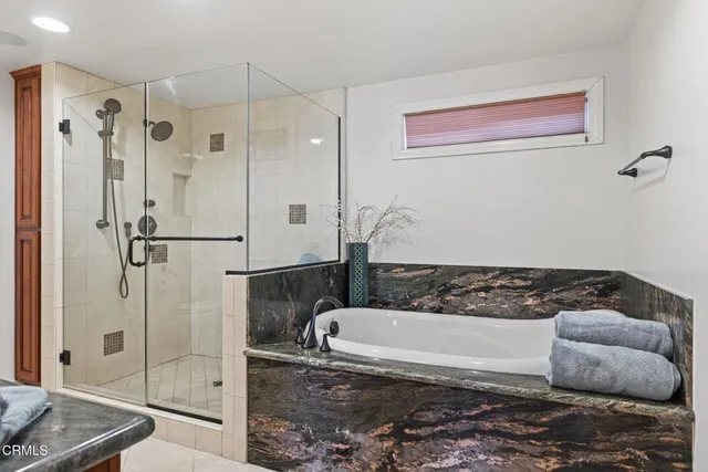 a bathroom with a bathtub and shower