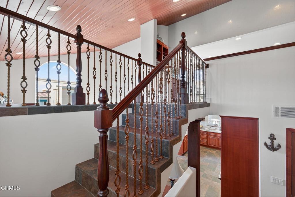 2408 Ocean Drive Oxnard, CA 93035 - Photo 29 of 58 a view of staircase with lots of frames on wall and a window