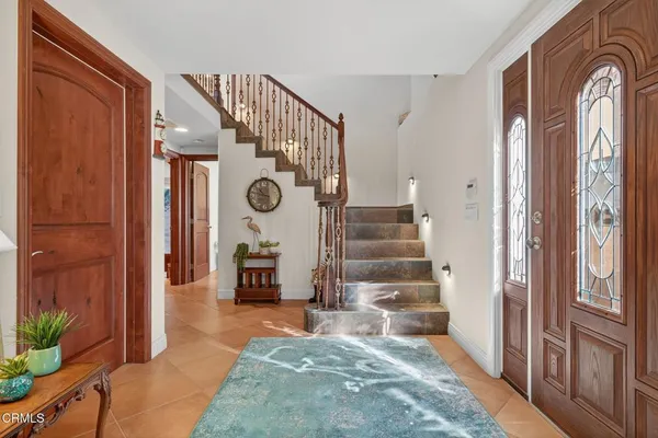 a view of an entryway with wooden floor and a livingroom view