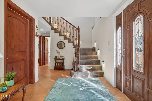 a view of an entryway with wooden floor and a livingroom view