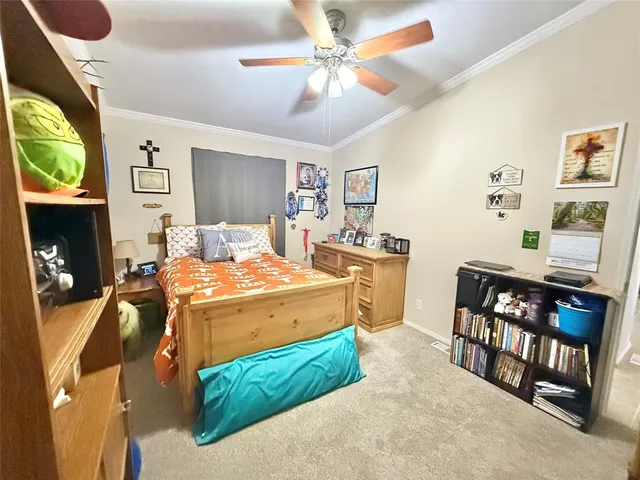 a bedroom with a bed a dresser and potted plants
