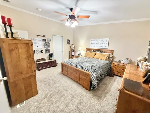 a bedroom with a bed dresser and a window