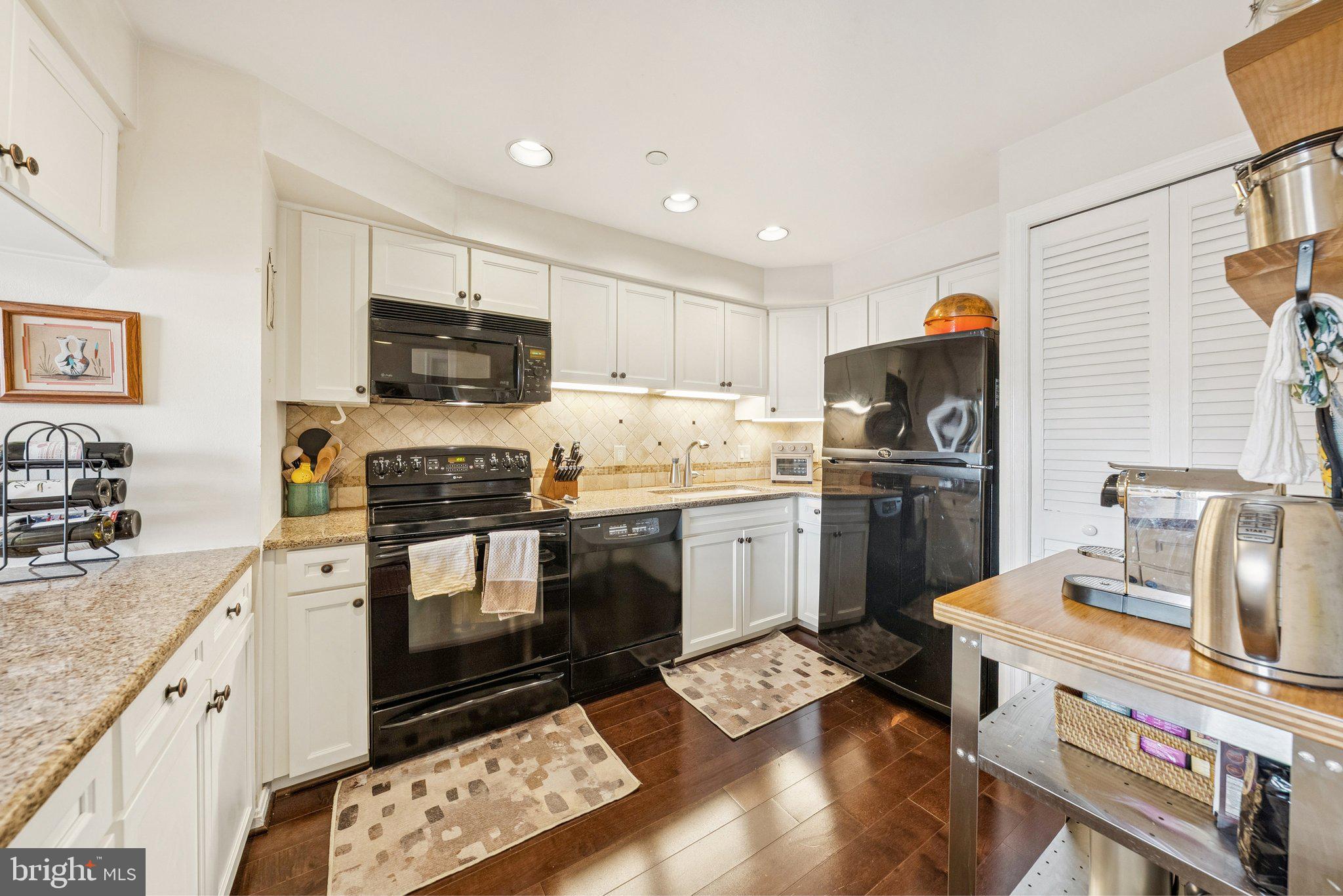 1301 North Courthouse Road, Unit 1810 Arlington, VA 22201 - Photo 2 of 29 a kitchen with a sink stove and refrigerator