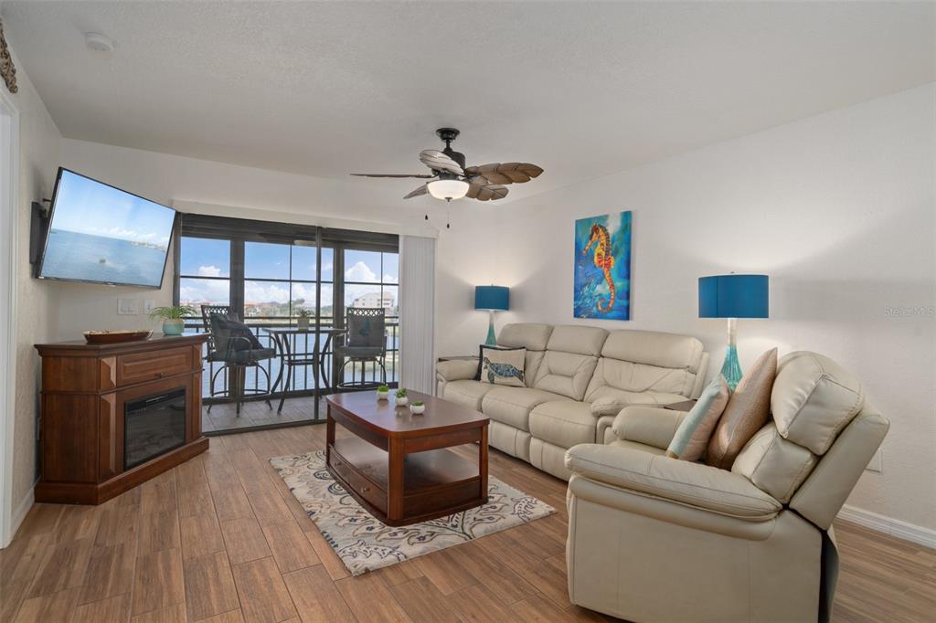 8211 Brent Street, Unit 847 Port Richey, FL 34668 - Photo 5 of 29 a living room with furniture and a flat screen tv