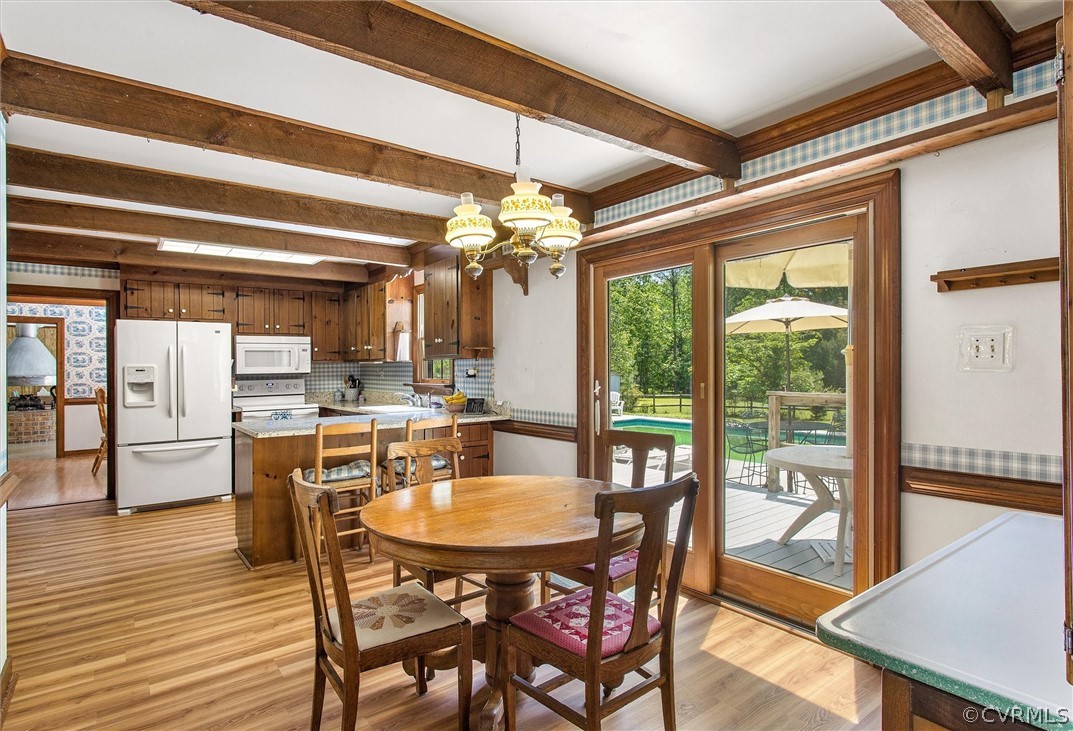 22601 Skinquarter Road Moseley, VA 23120 - Photo 11 of 50 a dining room with furniture a chandelier and wooden floor