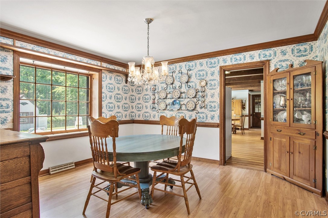 22601 Skinquarter Road Moseley, VA 23120 - Photo 17 of 50 a view of a dining room with furniture large window and wooden floor
